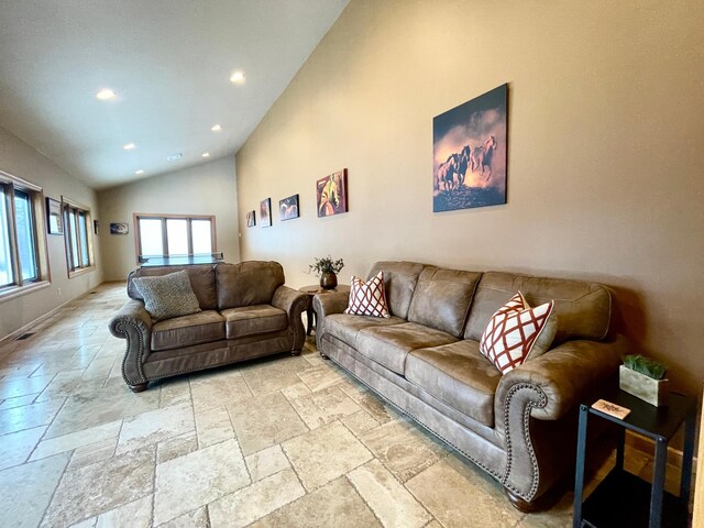 living room with high vaulted ceiling