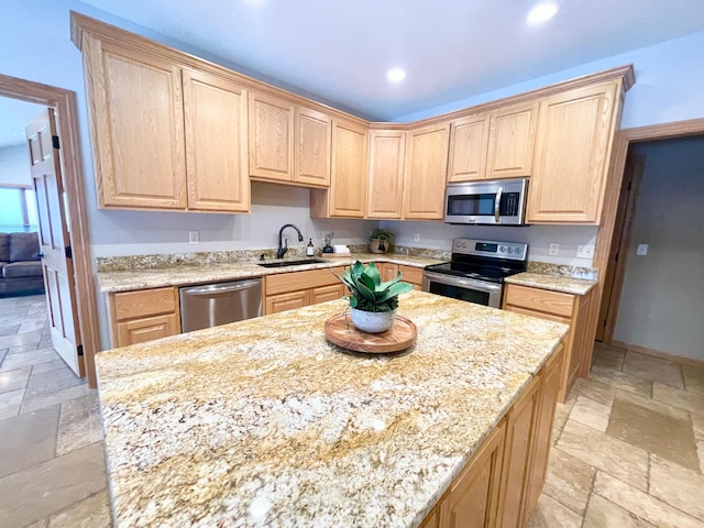 kitchen featuring appliances with stainless steel finishes, sink, and light brown cabinets