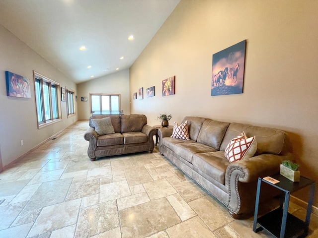 living room with high vaulted ceiling