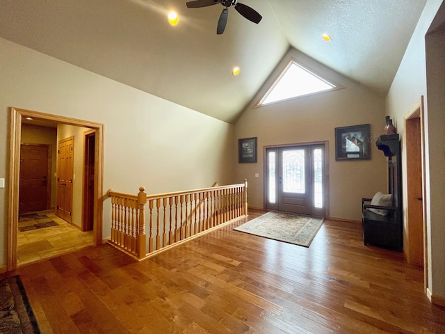 foyer entrance featuring hardwood / wood-style flooring and high vaulted ceiling