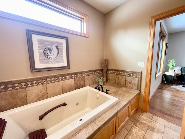 bathroom with tiled bath