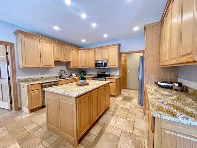 kitchen featuring a kitchen island, appliances with stainless steel finishes, and light brown cabinetry