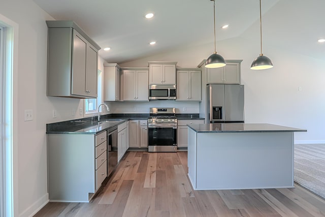 kitchen featuring hanging light fixtures, appliances with stainless steel finishes, sink, and gray cabinets