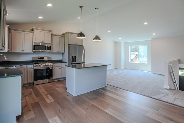 kitchen with gray cabinets, a center island, sink, hanging light fixtures, and stainless steel appliances