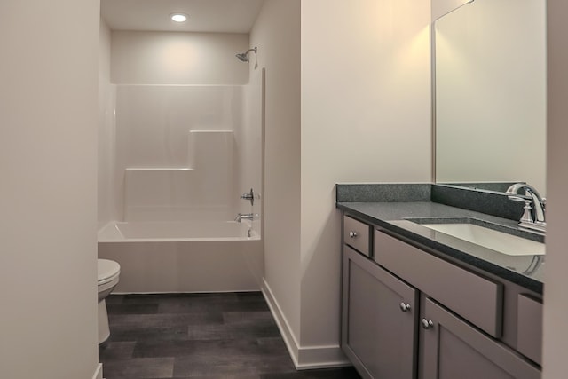 full bathroom featuring toilet, hardwood / wood-style flooring, vanity, and shower / bathing tub combination