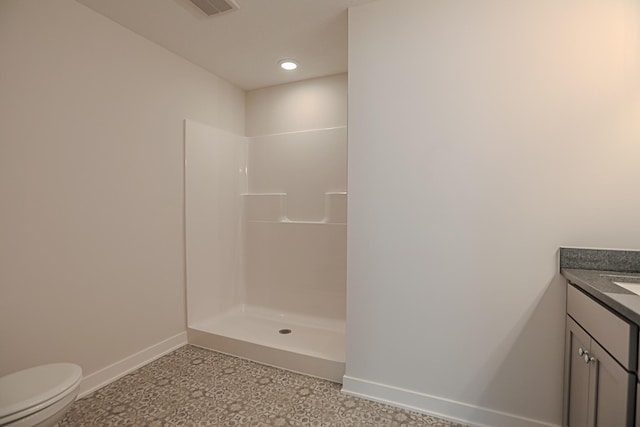 bathroom with a shower, toilet, and vanity