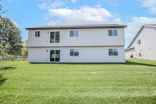 back of house with a lawn