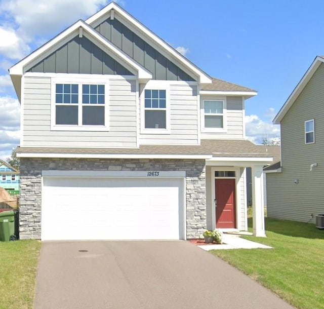 craftsman-style home featuring a front yard and a garage