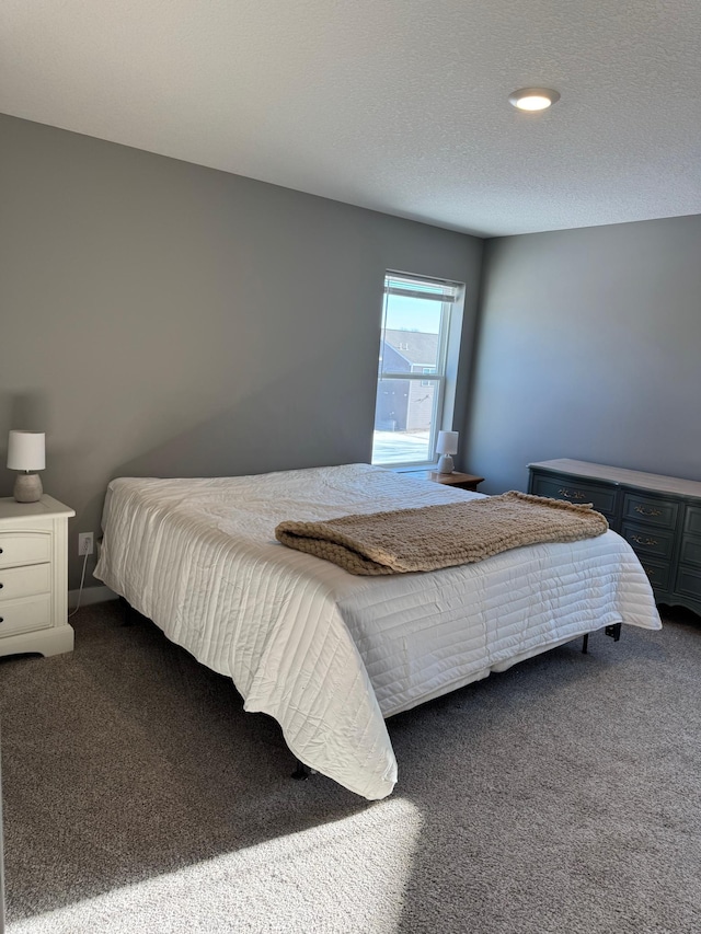 carpeted bedroom featuring a textured ceiling