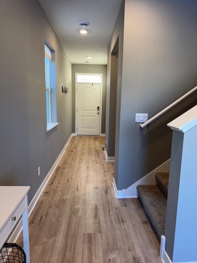 hallway with light hardwood / wood-style floors