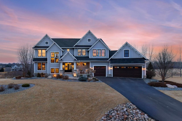 view of front facade with driveway, a shingled roof, board and batten siding, and an attached garage