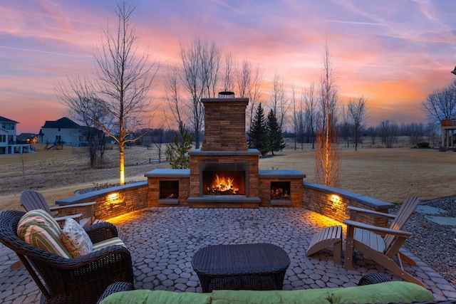 patio terrace at dusk with a warm lit fireplace