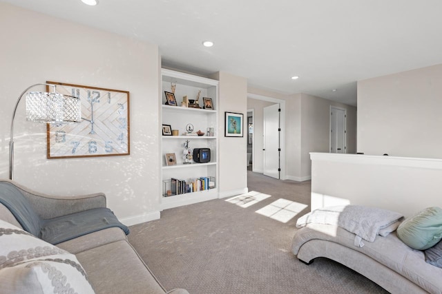 living area with carpet, built in shelves, baseboards, and recessed lighting