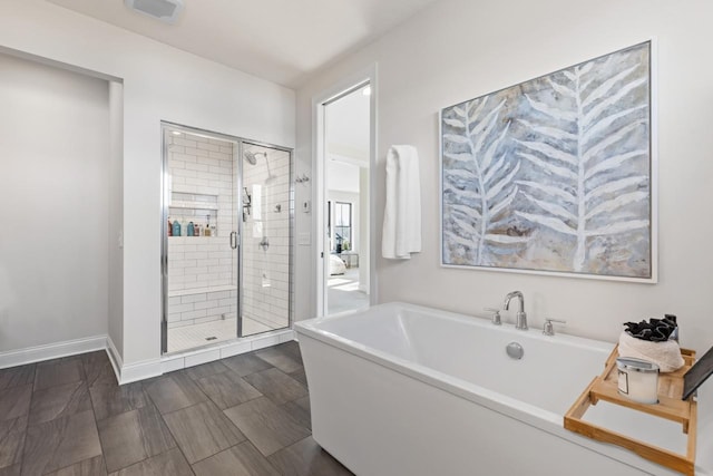 full bathroom with a soaking tub, a shower stall, visible vents, and baseboards