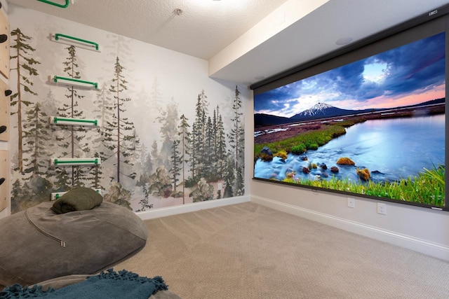 carpeted cinema room with a textured ceiling and baseboards