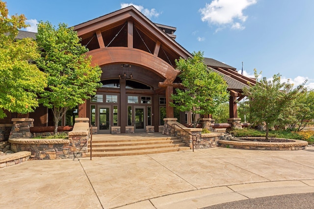 property entrance with a patio and french doors