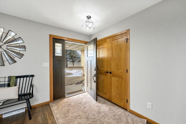 entryway with an inviting chandelier and hardwood / wood-style flooring