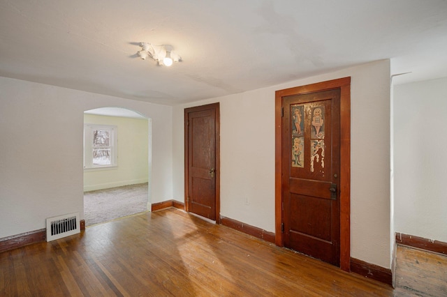 unfurnished room with wood-type flooring