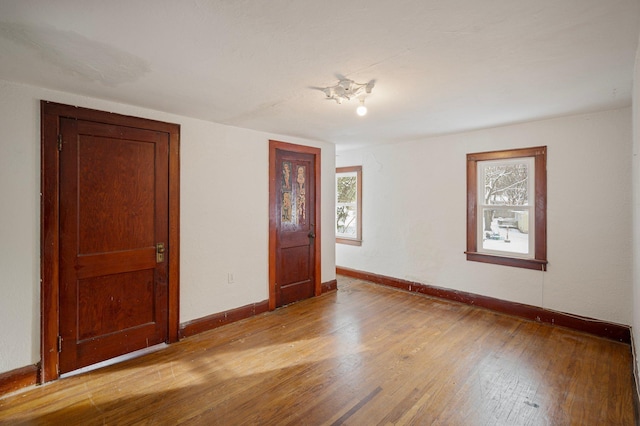 empty room with light hardwood / wood-style flooring