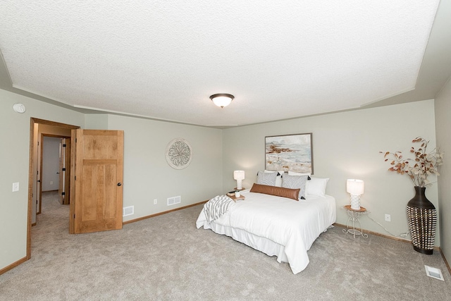 carpeted bedroom featuring a textured ceiling