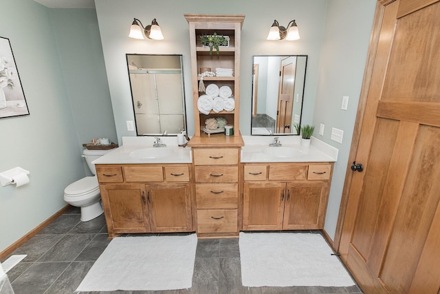 bathroom with toilet, vanity, and tile patterned flooring