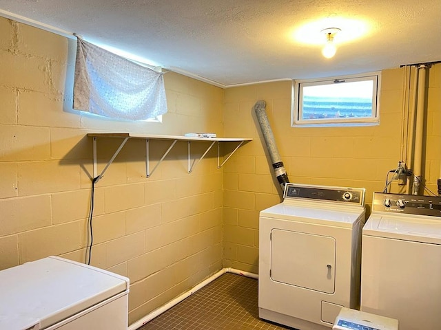 clothes washing area with separate washer and dryer