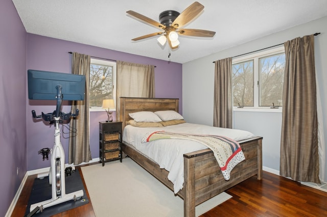 bedroom with a textured ceiling, dark hardwood / wood-style floors, and ceiling fan