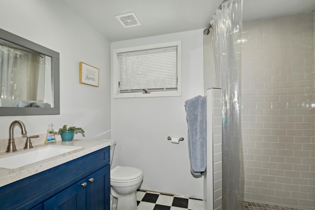 bathroom with vanity, walk in shower, and toilet