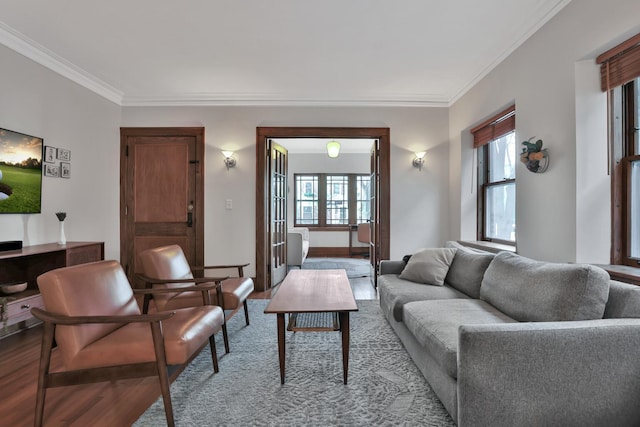 living room with hardwood / wood-style floors, a wealth of natural light, and ornamental molding