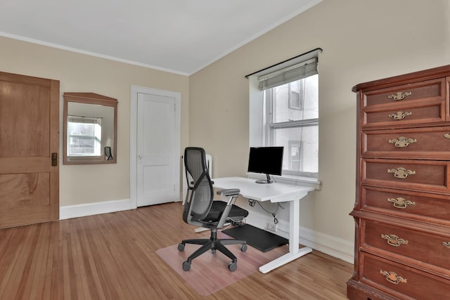 home office with baseboards, light wood-style floors, and ornamental molding