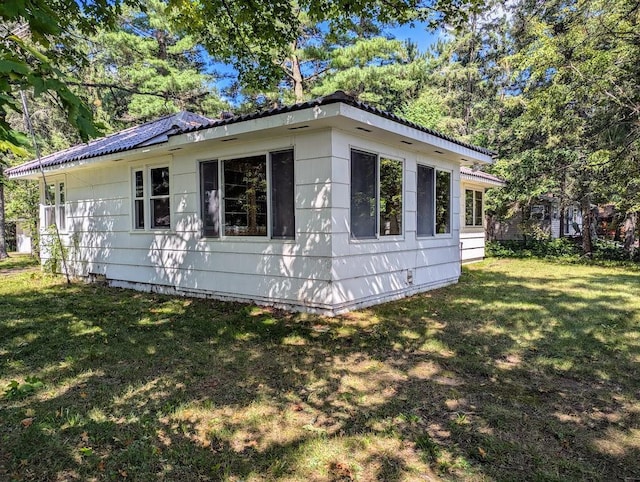 view of side of property with a yard