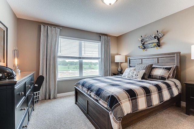 bedroom featuring light colored carpet and a textured ceiling