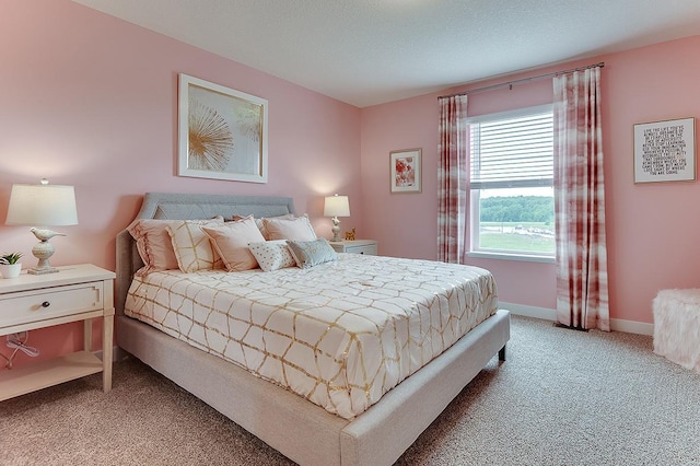 bedroom featuring carpet floors and a textured ceiling