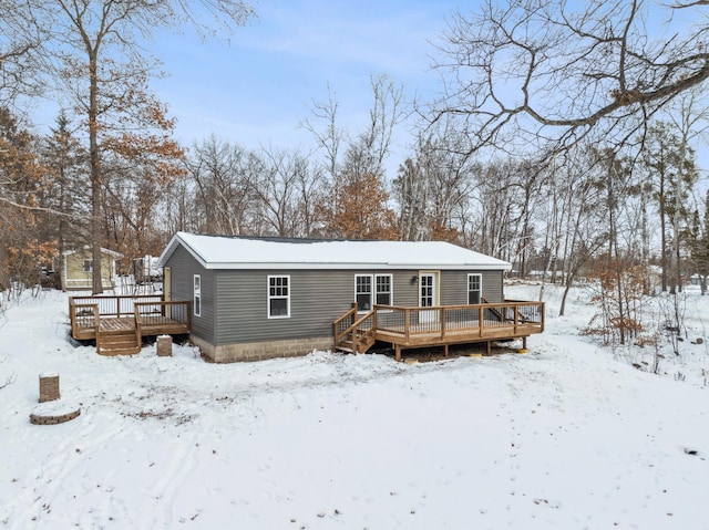 snow covered house with a deck