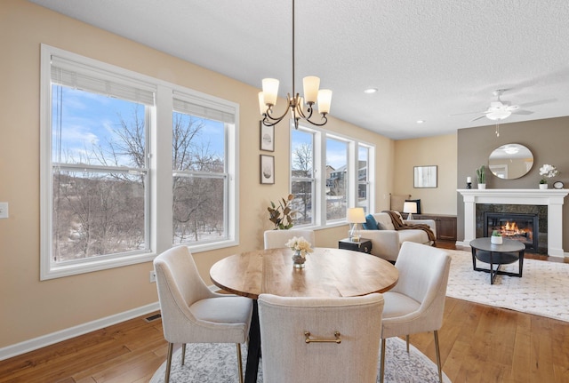 dining room featuring a notable chandelier, hardwood / wood-style flooring, and a textured ceiling