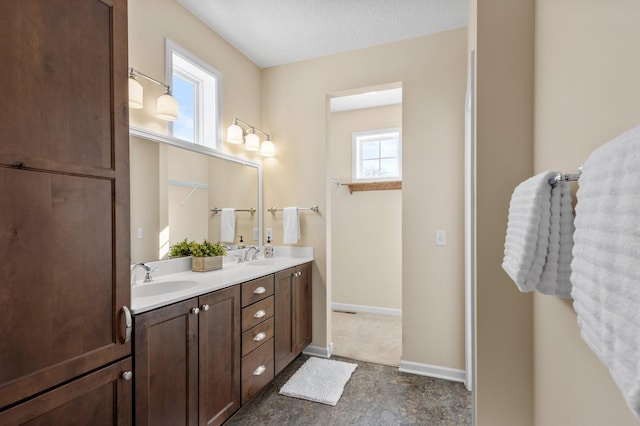 bathroom with a textured ceiling and vanity