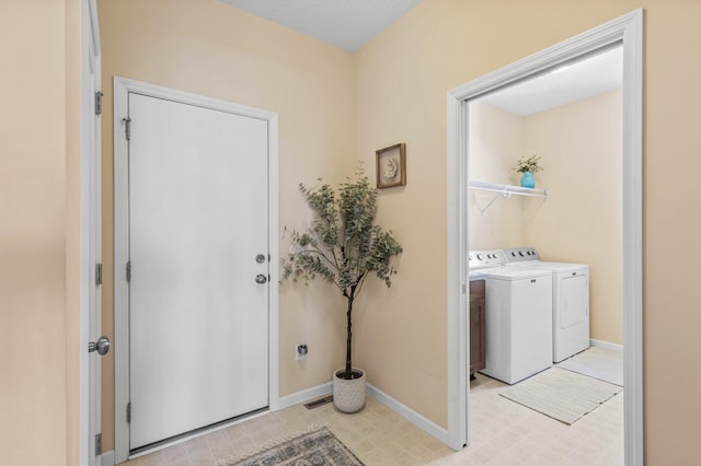 clothes washing area with washing machine and clothes dryer