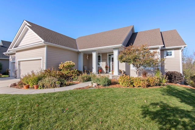 view of front of house featuring a front lawn, a garage, and a porch