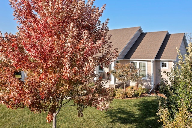 view of side of home with a lawn