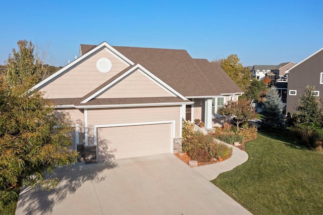 view of front of house with a front yard and a garage