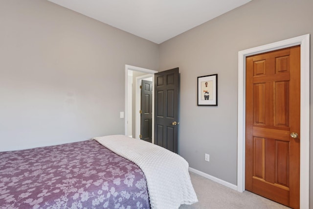 bedroom featuring light carpet