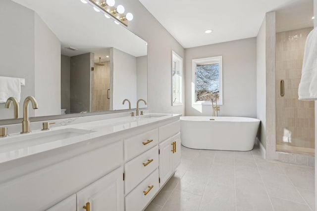 bathroom featuring tile patterned floors, plus walk in shower, and vanity