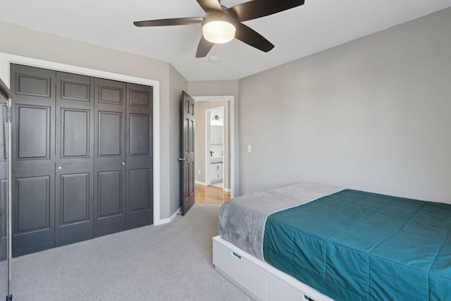 carpeted bedroom featuring a closet and ceiling fan