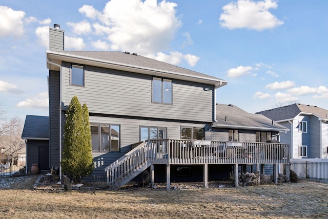 rear view of property featuring a wooden deck