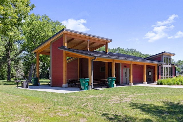 exterior space with a patio and a lawn