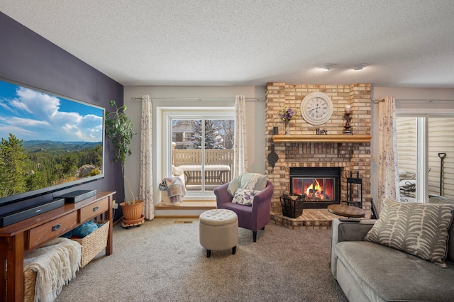 carpeted living room featuring a brick fireplace and a textured ceiling