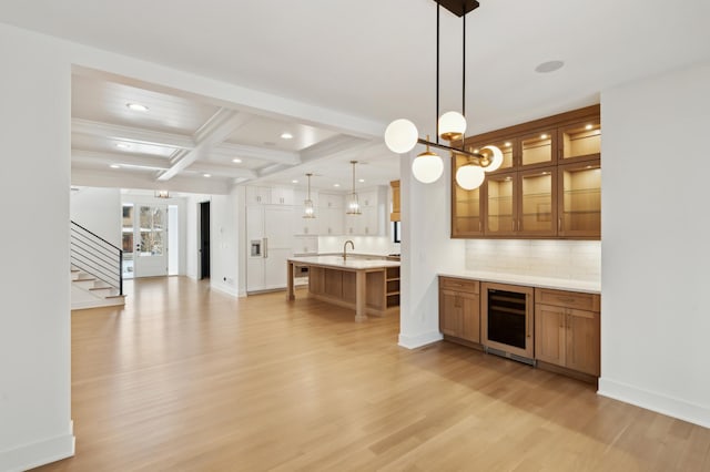 bar featuring beam ceiling, tasteful backsplash, hanging light fixtures, light hardwood / wood-style floors, and wine cooler