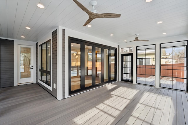 wooden deck featuring ceiling fan