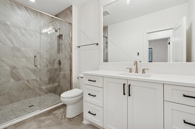 bathroom featuring toilet, vanity, and an enclosed shower