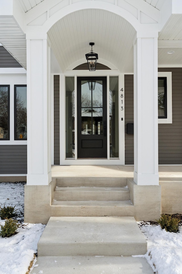 view of snow covered property entrance